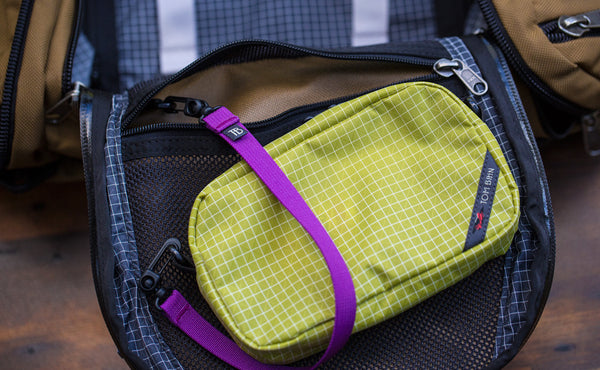 A 16-inch Key Strap attaching a 3D Organizer Cube to the interior pocket of a bag.